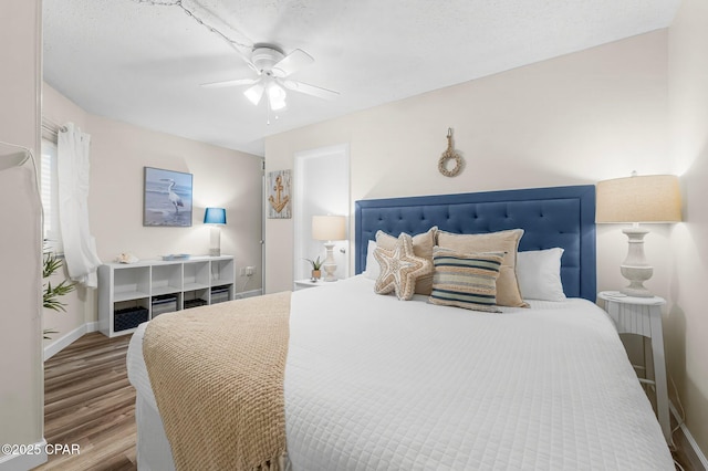 bedroom with ceiling fan and hardwood / wood-style flooring