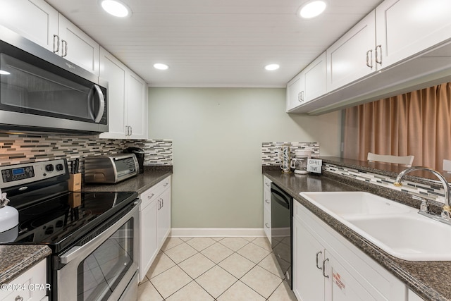 kitchen with stainless steel appliances, white cabinetry, and sink