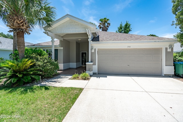 view of front of home featuring a garage and a front lawn