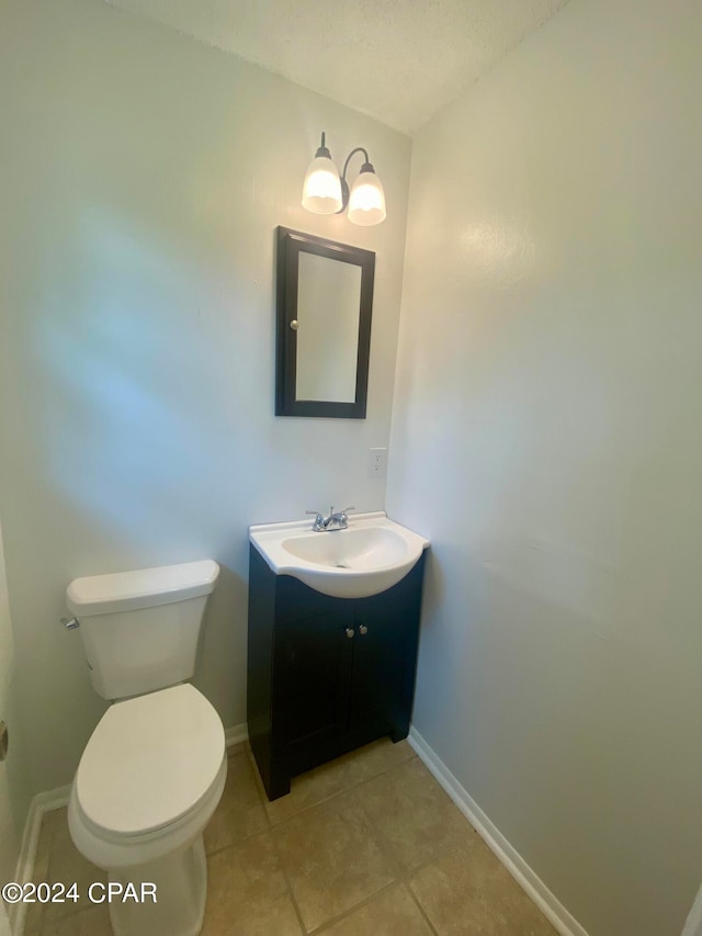 bathroom featuring tile patterned flooring, vanity, and toilet