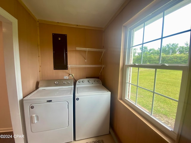 washroom featuring electric panel, a wealth of natural light, and independent washer and dryer