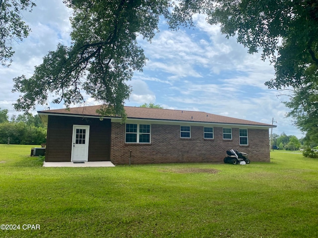 back of house with a yard, a patio area, and central air condition unit