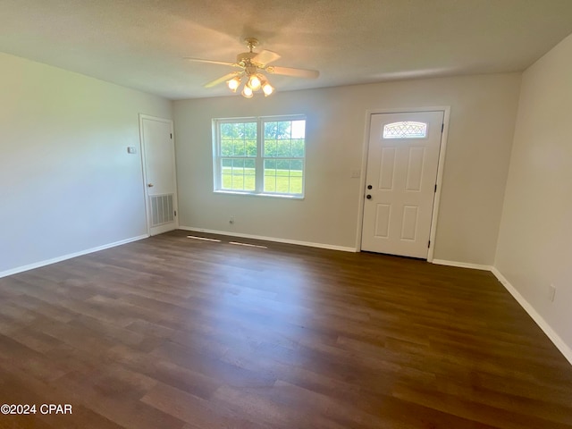 foyer entrance featuring dark hardwood / wood-style floors, ceiling fan, and a textured ceiling