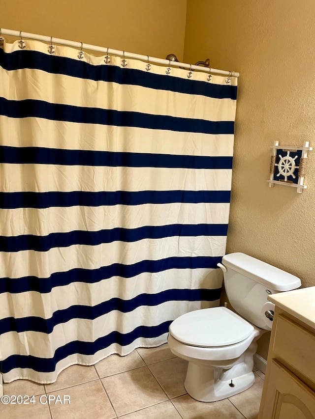 bathroom with tile patterned flooring, vanity, toilet, and a shower with shower curtain