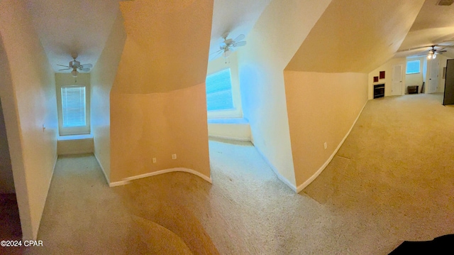 hall featuring light colored carpet and lofted ceiling