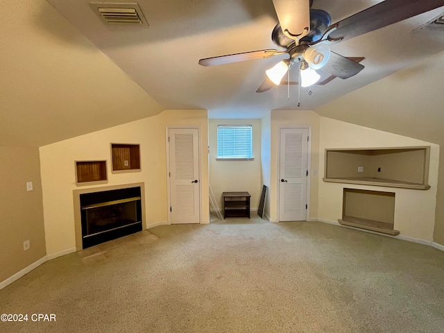 unfurnished living room featuring ceiling fan, light carpet, and vaulted ceiling