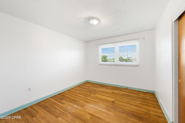 empty room with light wood-style flooring and baseboards