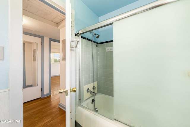 full bath featuring enclosed tub / shower combo and wood finished floors