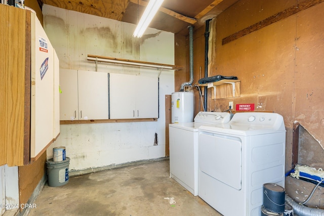 laundry room featuring water heater, washer and clothes dryer, and cabinet space