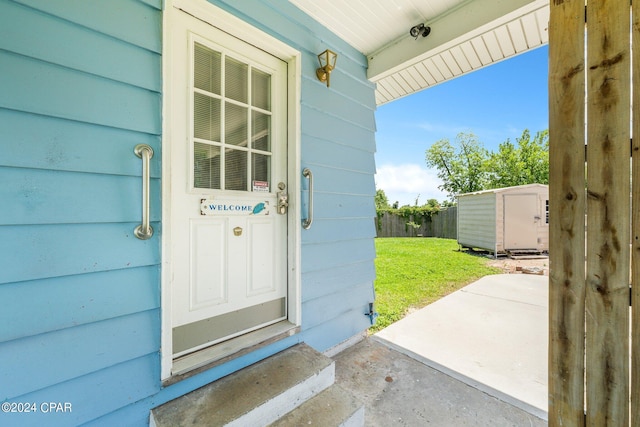 entrance to property with fence and a yard