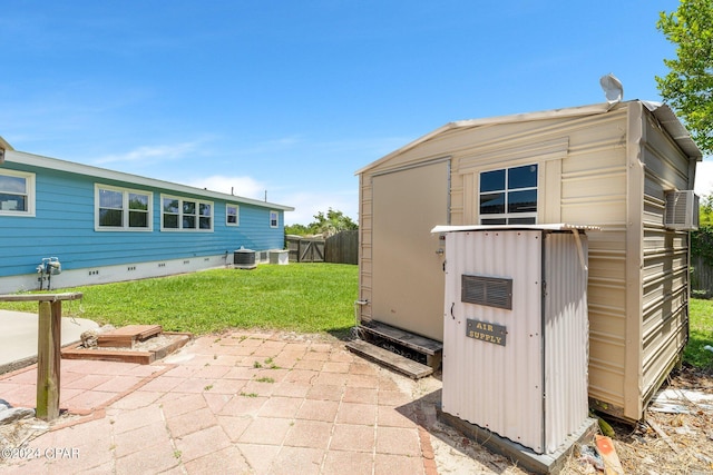 view of shed featuring cooling unit and fence