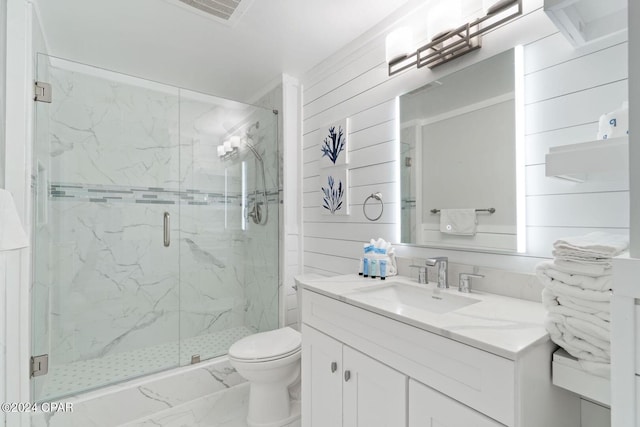 bathroom with walk in shower, wood walls, vanity, and toilet