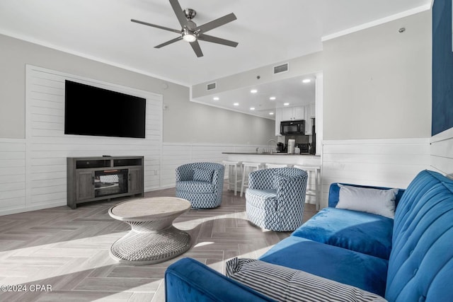 living room featuring ceiling fan, sink, and light parquet floors