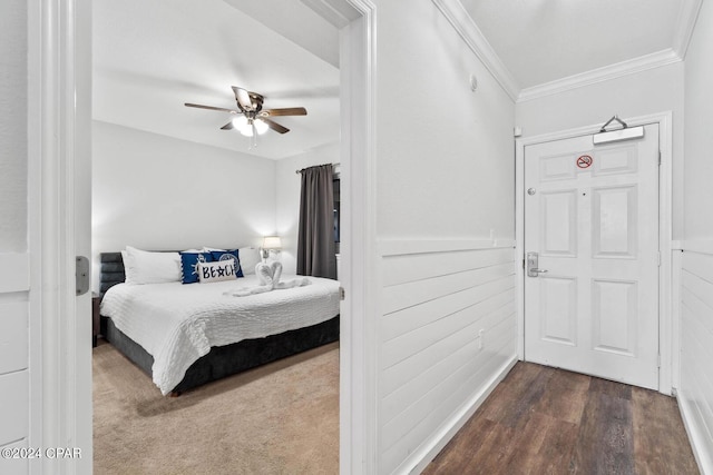 bedroom with wood-type flooring, ceiling fan, and crown molding