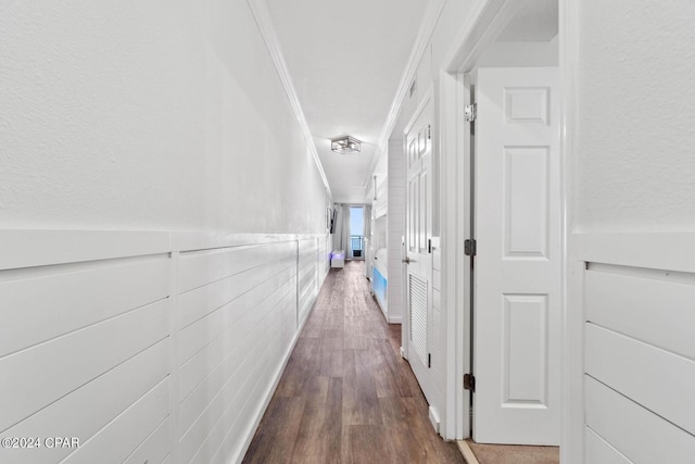 hallway featuring ornamental molding and dark wood-type flooring