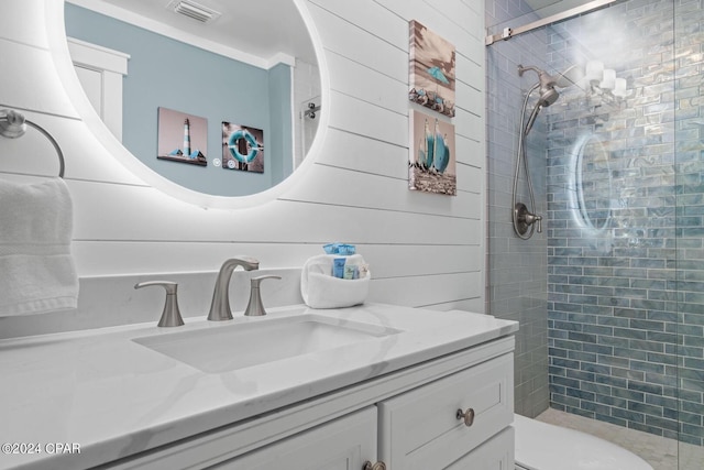 bathroom featuring vanity, wood walls, an enclosed shower, and toilet