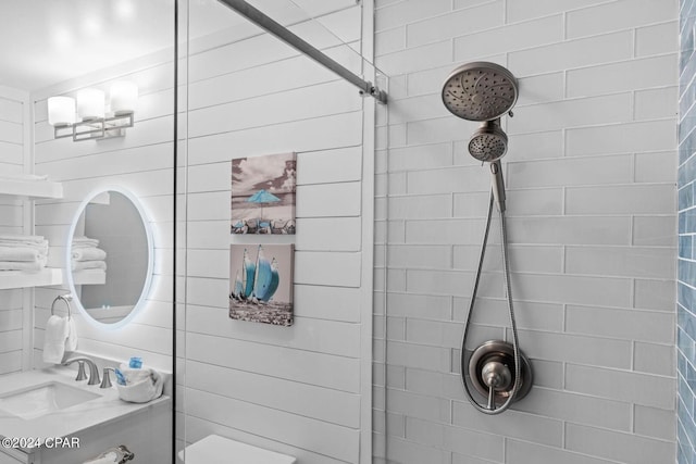 bathroom featuring vanity, toilet, and tiled shower