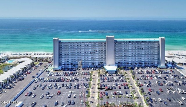 birds eye view of property with a water view and a beach view