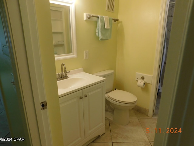 bathroom featuring tile patterned floors, vanity, and toilet