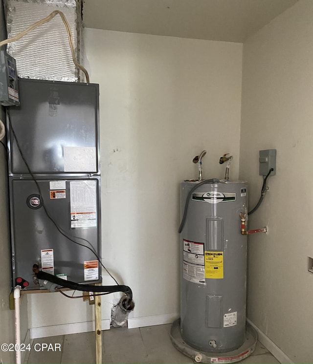 utility room with heating unit and electric water heater