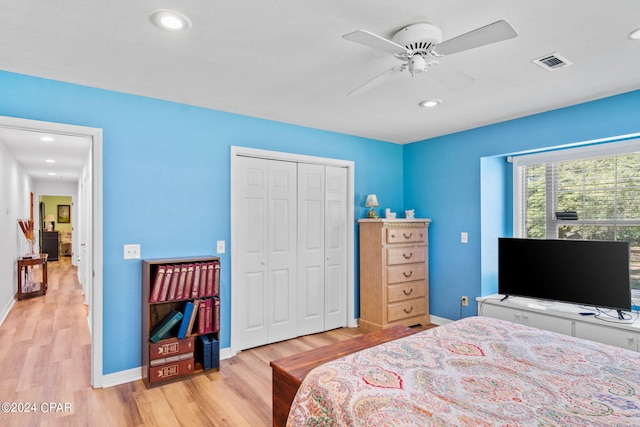 bedroom with ceiling fan, a closet, and light wood-type flooring