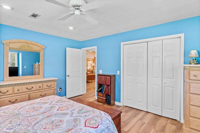 bedroom featuring ceiling fan, a closet, and light hardwood / wood-style floors