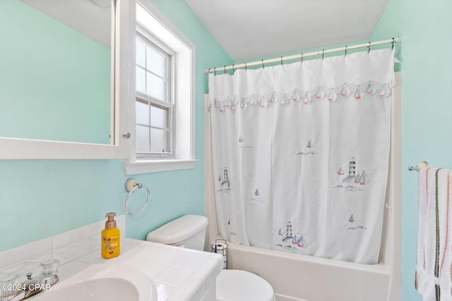 full bathroom featuring shower / bath combo, vanity, and toilet