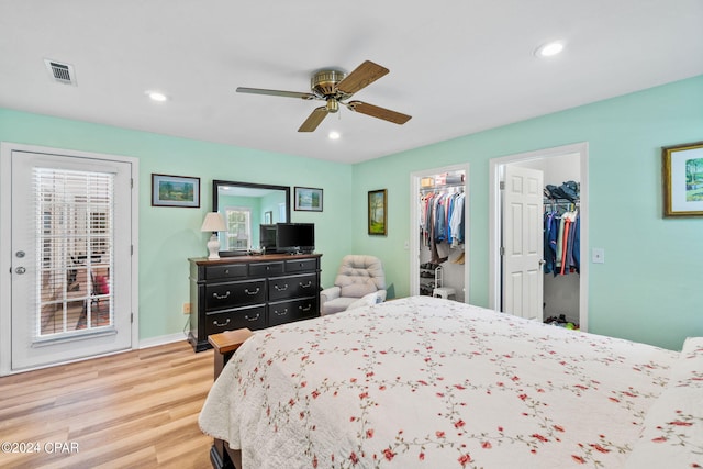 bedroom featuring wood-type flooring, a closet, a spacious closet, and ceiling fan