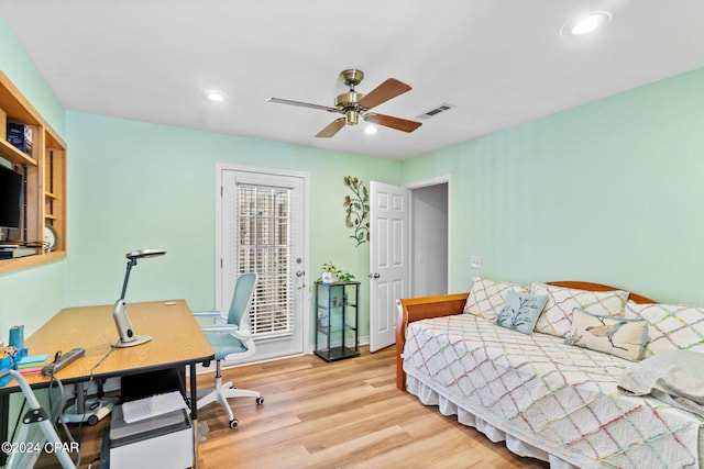 home office featuring light hardwood / wood-style floors and ceiling fan