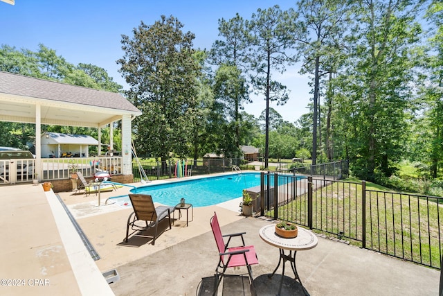 view of swimming pool featuring a yard and a patio