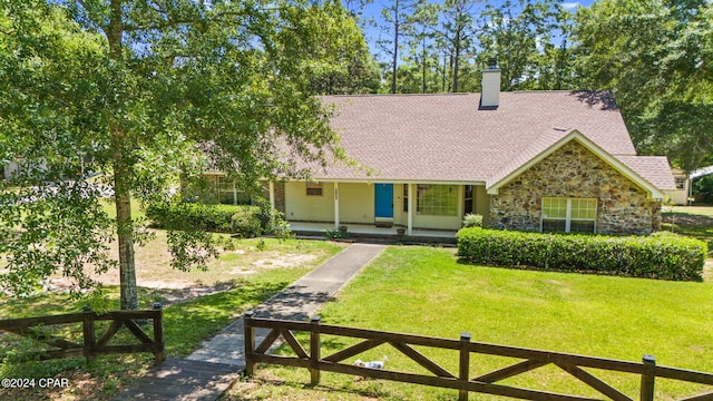 view of front of property with covered porch and a front lawn