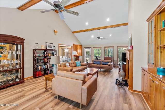 living room with beamed ceiling, ceiling fan, light wood-type flooring, and high vaulted ceiling