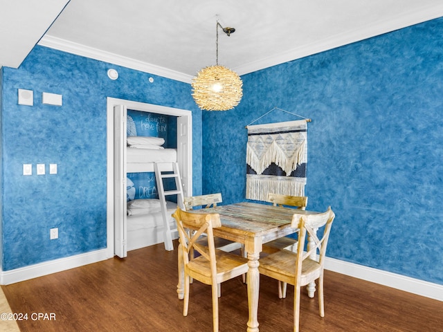 dining space featuring crown molding and dark hardwood / wood-style floors