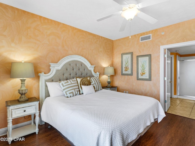 bedroom with dark hardwood / wood-style floors and ceiling fan