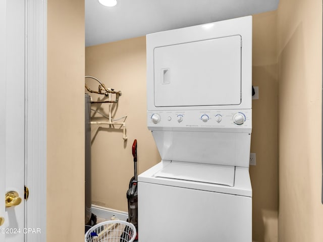 clothes washing area with stacked washer / dryer