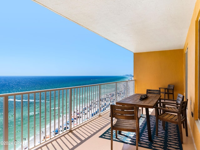 balcony with a water view and a beach view