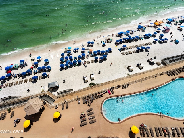 drone / aerial view with a beach view and a water view