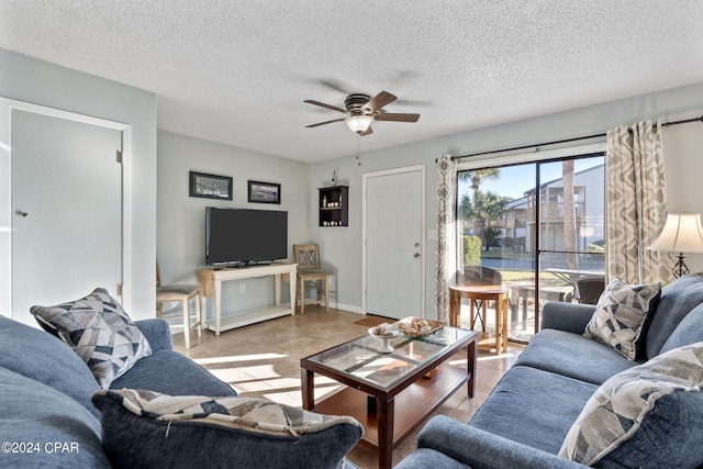 living room with ceiling fan and a textured ceiling