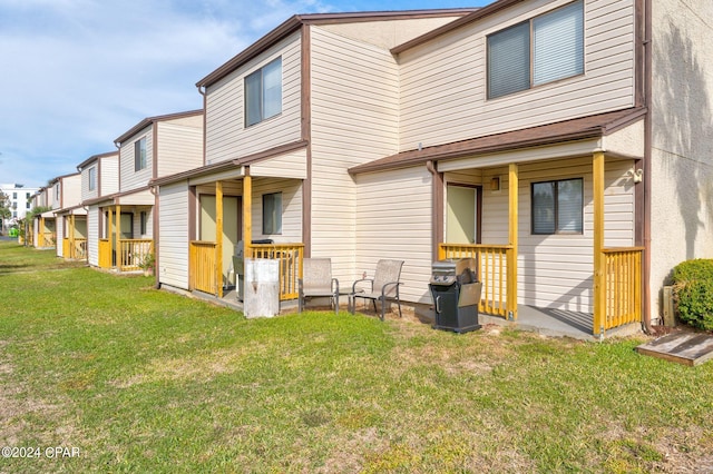 rear view of property with a yard