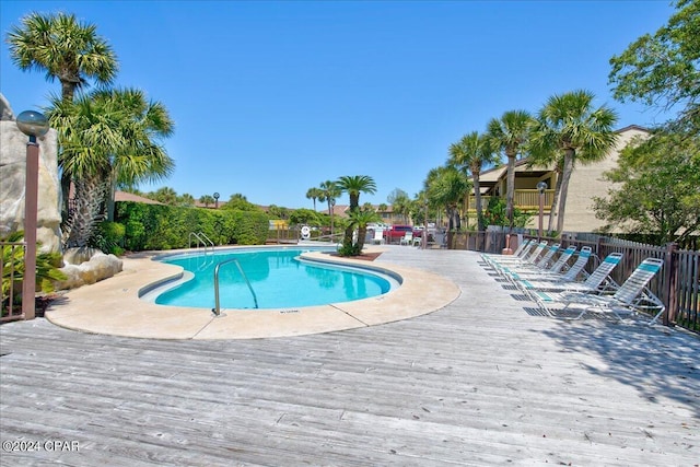 view of pool with a wooden deck