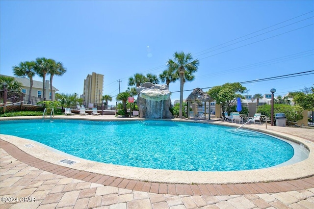 view of pool featuring pool water feature and a patio area