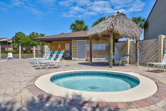 view of pool featuring a patio area and a community hot tub