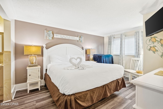 bedroom featuring wood-type flooring, a textured ceiling, and ornamental molding