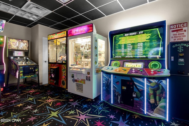 game room with a paneled ceiling