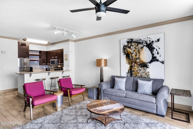 living room featuring crown molding, light hardwood / wood-style flooring, and ceiling fan