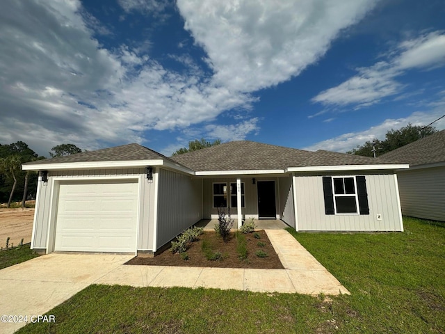 ranch-style house featuring a porch, a garage, and a front lawn