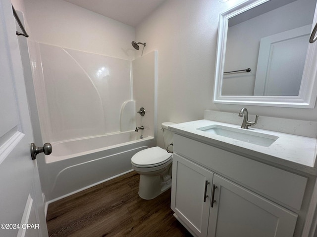 full bathroom featuring hardwood / wood-style flooring, vanity,  shower combination, and toilet