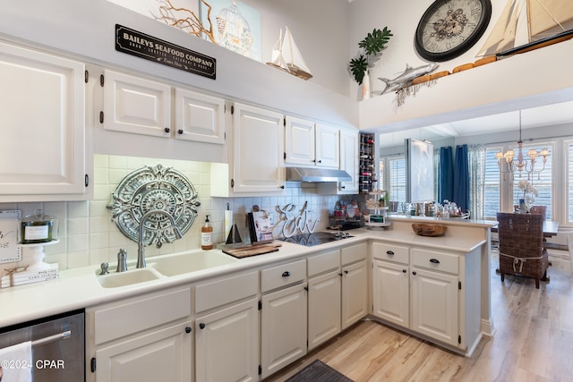 kitchen with white cabinets, sink, and light hardwood / wood-style flooring