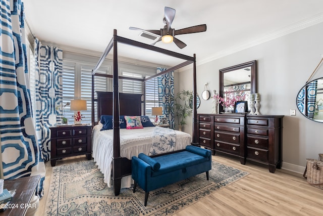 bedroom with ceiling fan, crown molding, and light hardwood / wood-style floors