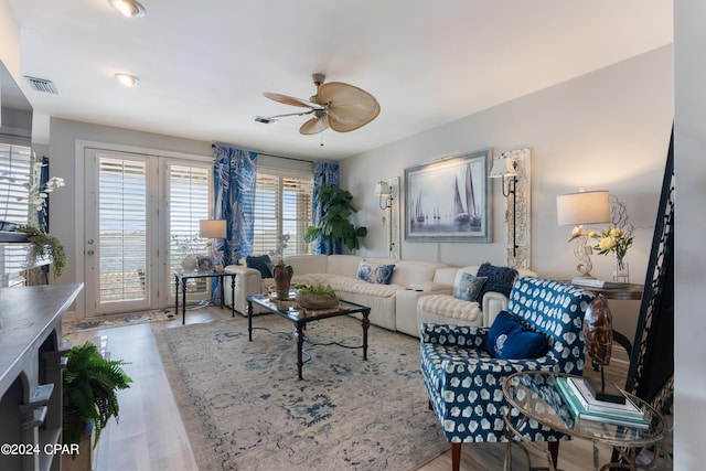 living room with ceiling fan and wood-type flooring